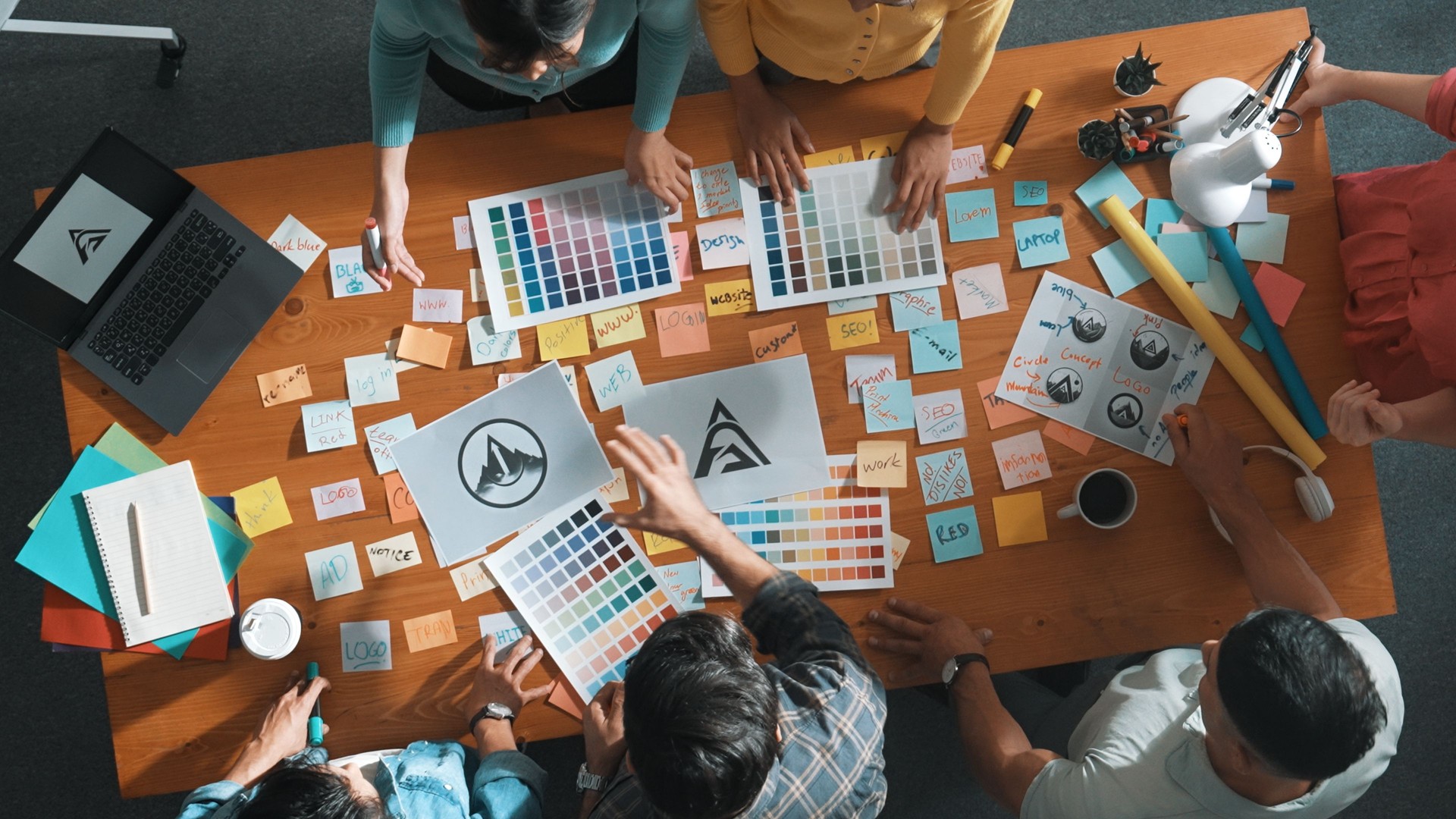 Top view of smart business team write graphic logo on meeting table. Symposium.